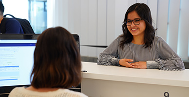 Student talking with employee