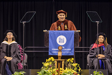 Chancellor Steven Gonzales speaking at the graduation podium