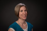 Smiling woman with chin length sandy brown hair 