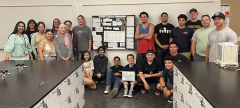 Asmita Kane standing with 20 students in a classroom