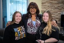 MCC President, Dr. Tammy Robinson, poses with two iBelong program participants. 