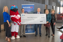 College leaders, Mesa city council members, AT&amp;T representative with MCC's mascot posing with an oversized check for $70K from AT&amp;T