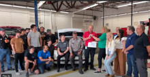 MCC students, faculty and leadership with SRP representatives gathered by electric vehicle. 