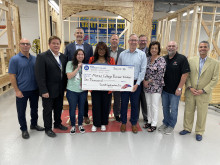 Representatives from Sundt Construction MCC and City of Mesa Mayor Giles standing around an oversized check for 0,000. 